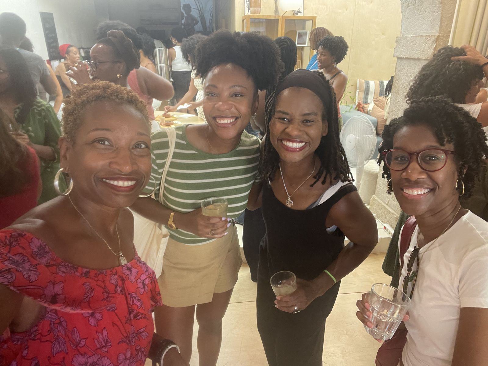 Four BWIT Lisbon members smiling together at a community gathering